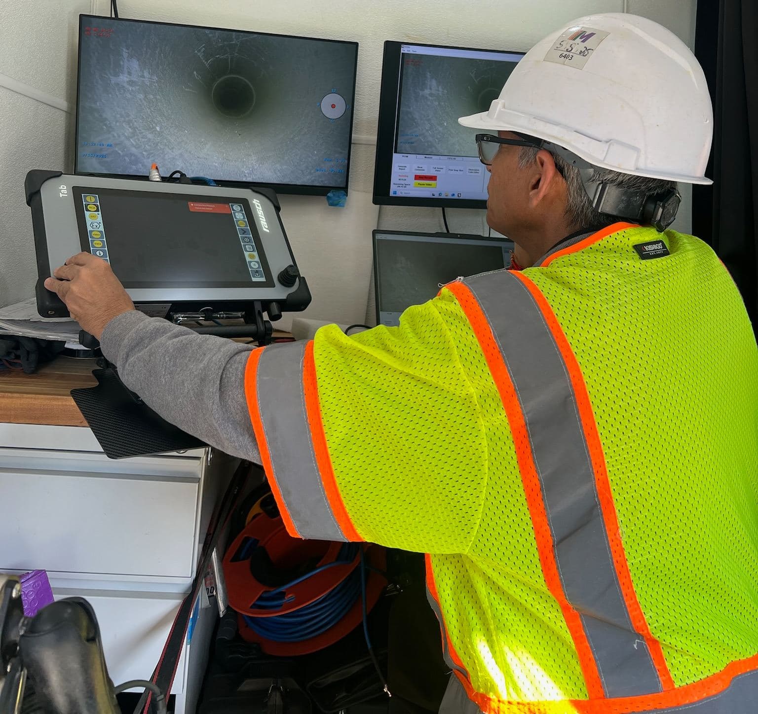 CCTV operator reviewing pipeline footage in the inspection truck